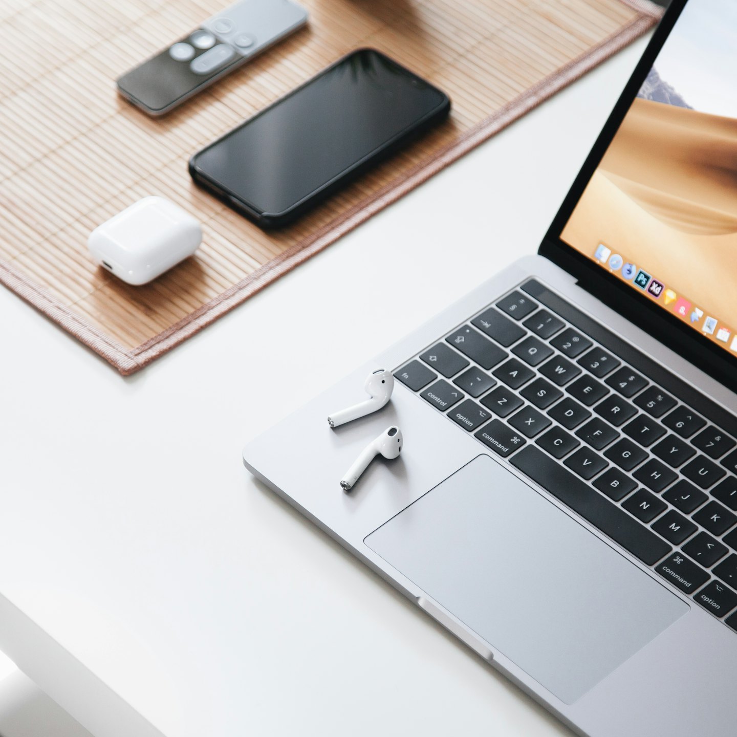 Modern electronic devices arranged on a white desk.